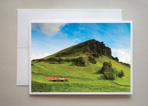 A house sits snuggly in the base of a jagged green hill in this unique greeting card by photographer Alicia Campbell.