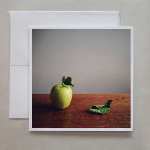 Teacher's apple!  The lighting is brilliant is this photo card of a Granny apple and leaf by photographer Jennifer Echols.